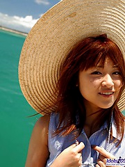 Beautiful Asian teen enjoys modeling her sexy teeny bikinis by the ocean