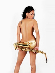 Janice in panties playing the saxophone topless